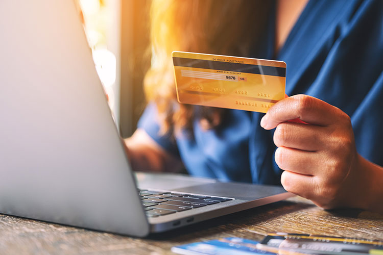 woman with credit card on laptop taxes