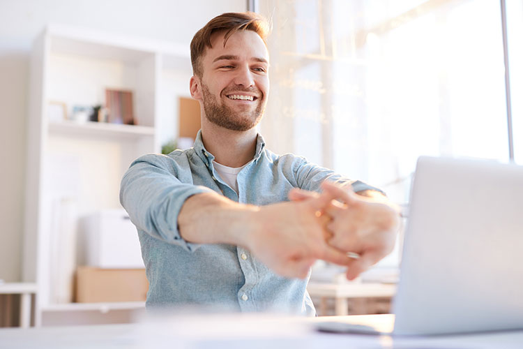 man on laptop doing taxes