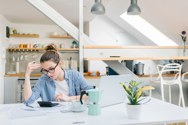 woman in kitchen doing taxes