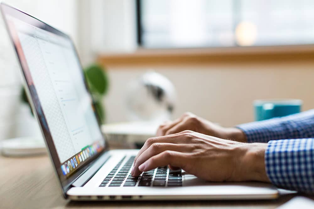 person on laptop submitting their tax