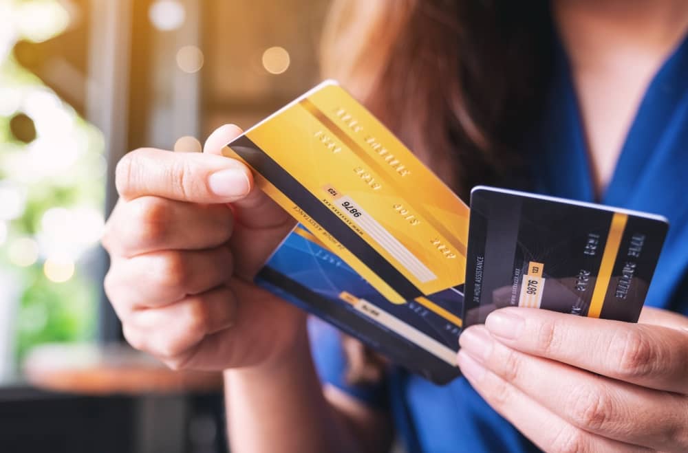 Woman choosing credit card to use.
